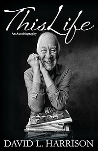 Cover featuring the author with a stack of his books